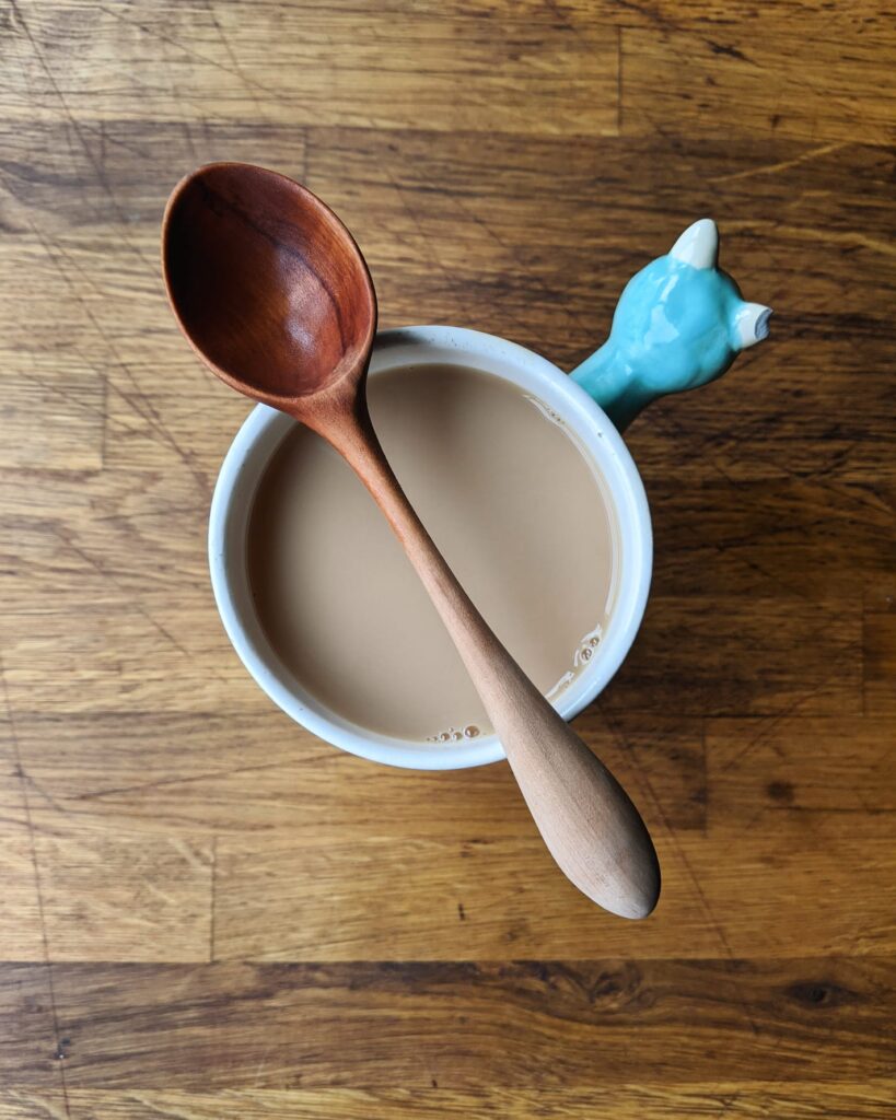 Spoons 3 A hand-carved wooden spoon balanced on a mug of tea.